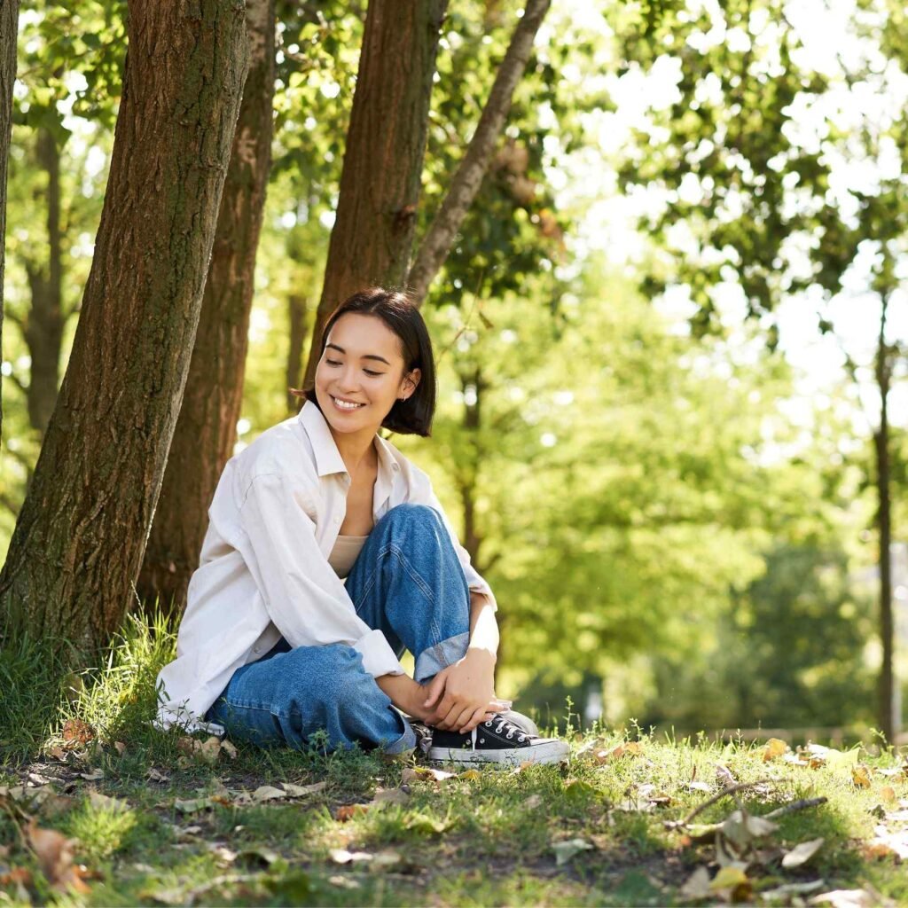 Woman sitting under a tree