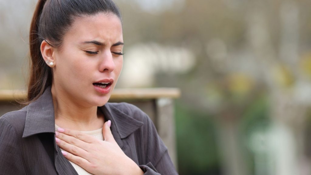 A woman struggling with breathing after taking cough syrup with codeine