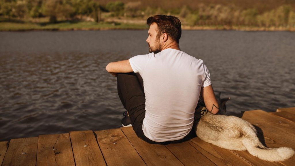 a man rub his dog for coping with behavioral changes and mental from meth