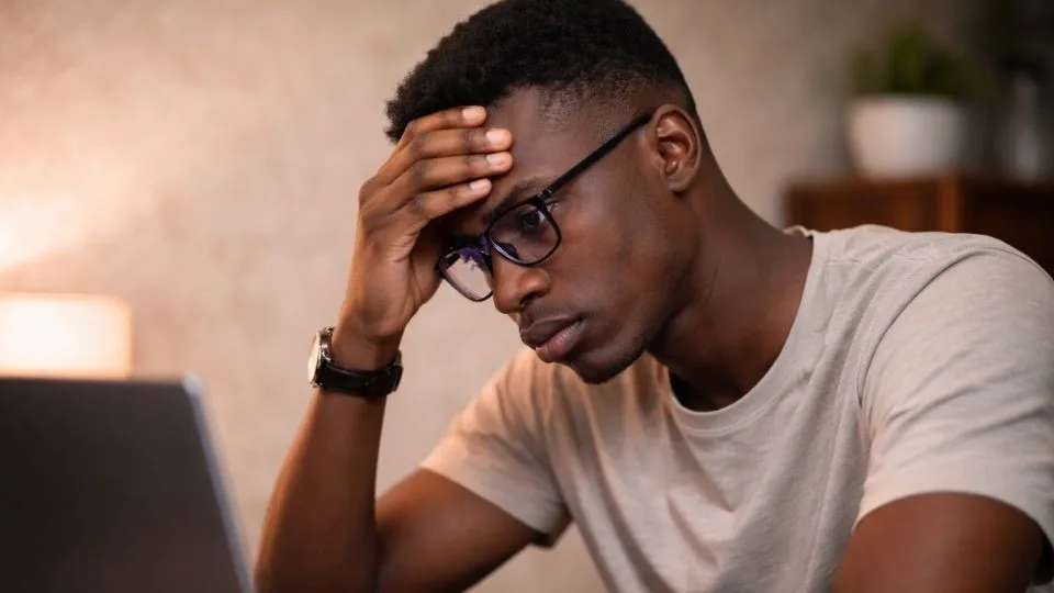 What Is 7 OH? a man with glasses looks up the answer on his computer.