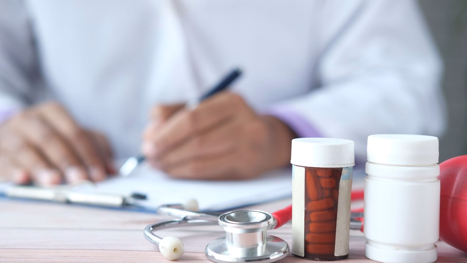 a doctor writing a prescription to treat opioid use disorder to treat opioid use disorder
