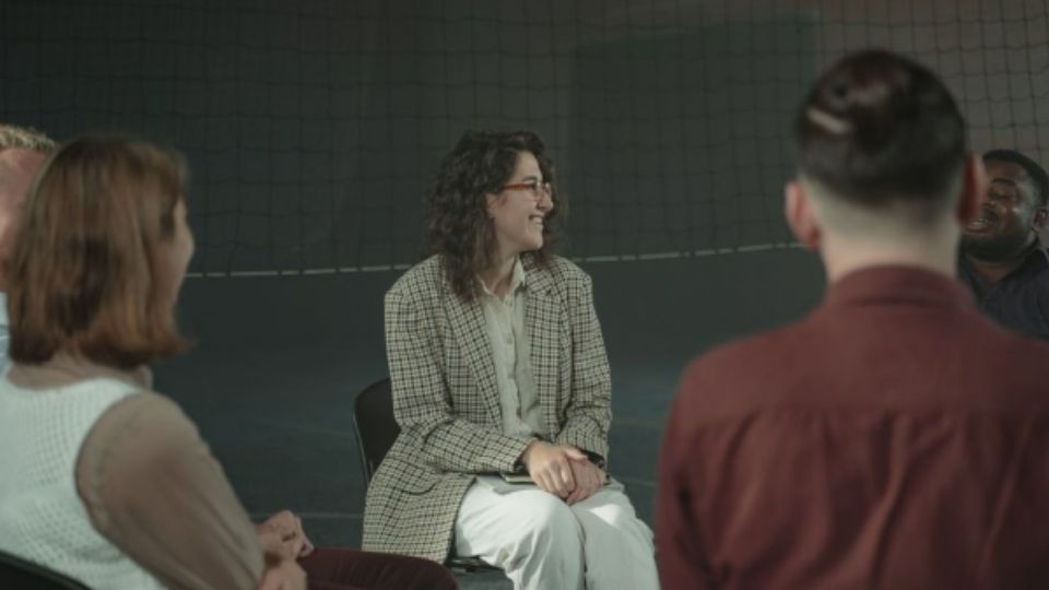 Family members at a support group meeting learning how to support a loved one through addiction